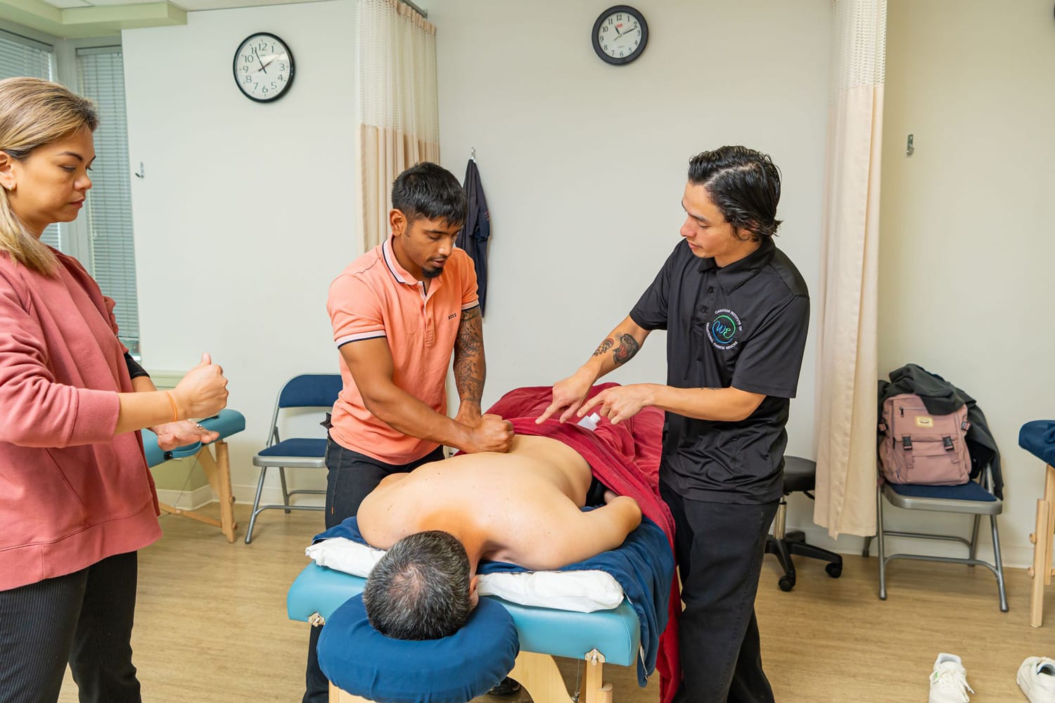 Massage therapy students learning Western and Eastern massage therapy techniques in CITCM student clinic.